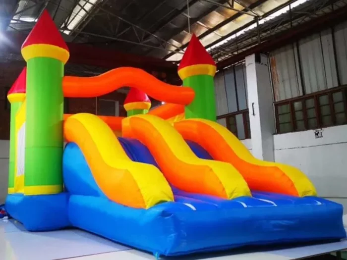 Colorful inflatable castle bouncy castle with dual yellow slides and vibrant towers, perfect for kids' parties. Buy online in NZ for endless fun.